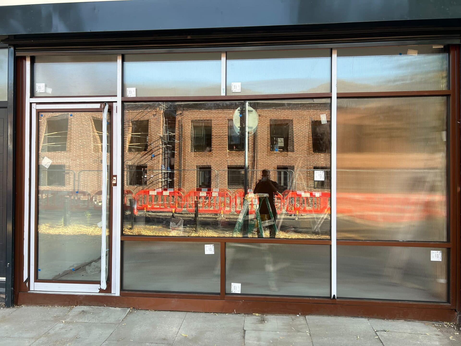 Bronze aluminium shopfront with full-height glazing panels